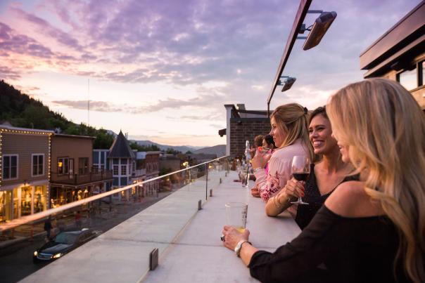 Women enjoying cocktails at Spur Bar overlooking Historic Main Street