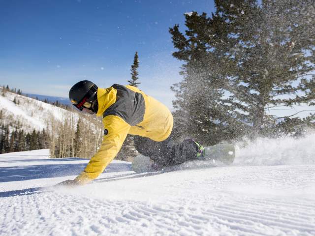 Snowboarder on groomer at Park City Mountain