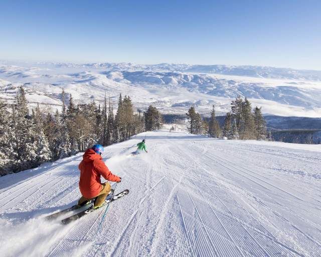 Sunny Day with Couple Skiing on Groomer at Deer Valley