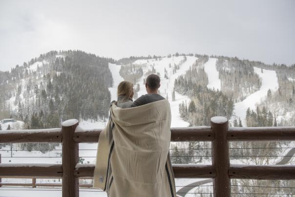 Couple wrapped in a blanket on Flagstaff deck at Stein Eriksen Lodge