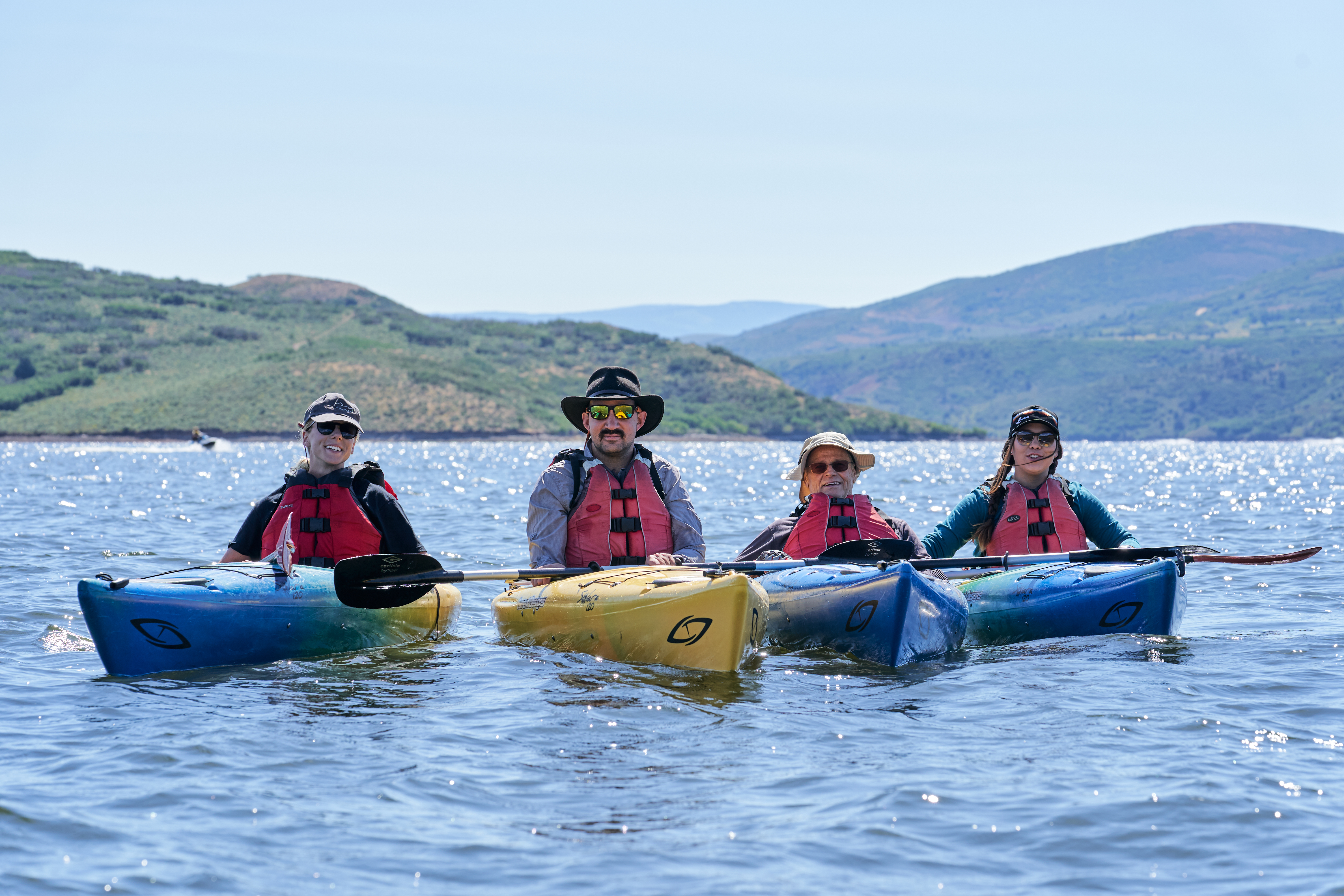 Four people in Kayaks on a lake