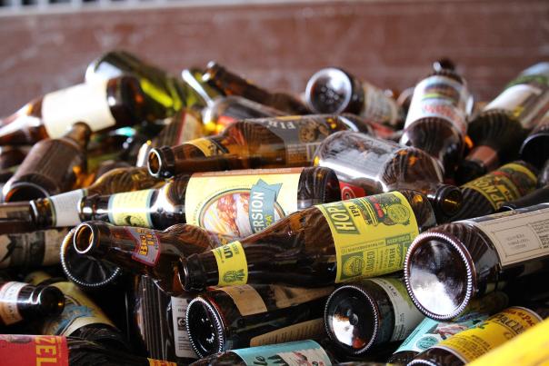 Glass bottles piled up waiting to be recycled.