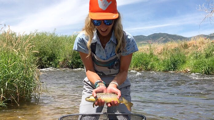 happy fisherman holding a fish