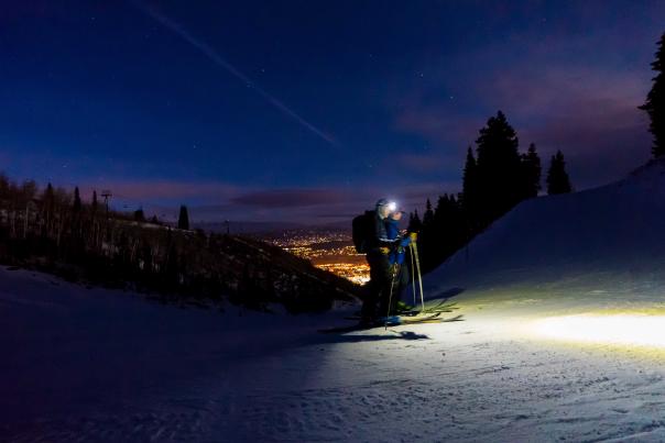 Two skiers tour on Park City Mountain with headlamps