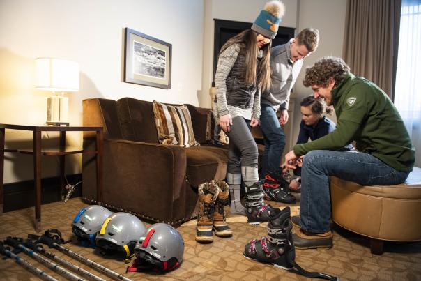 Man helping a women try on ski boots