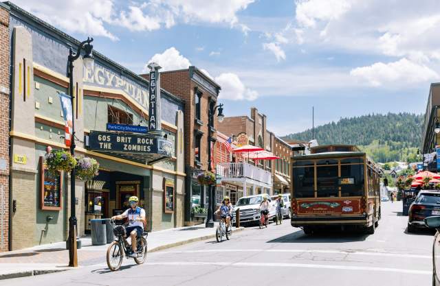 group riding bikes down main street passing the trolly