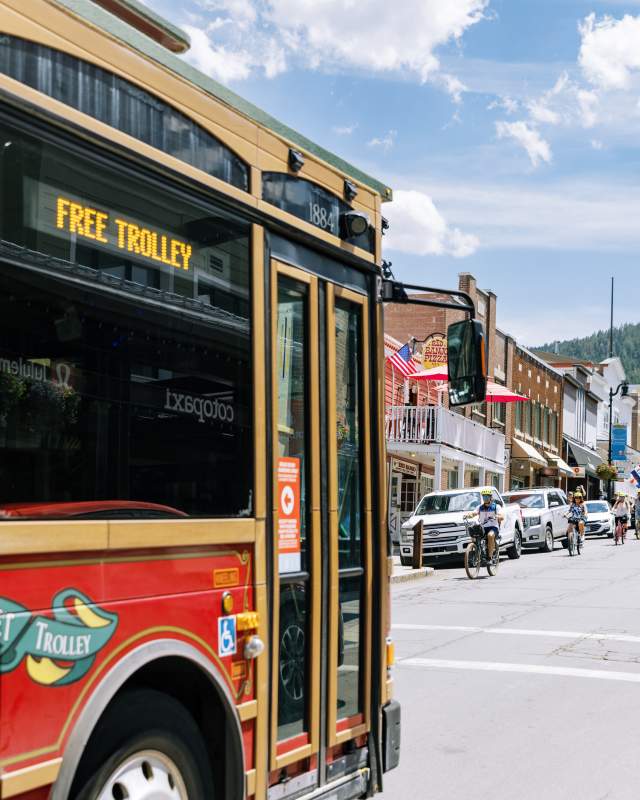 Trolly driving up main street during the summer