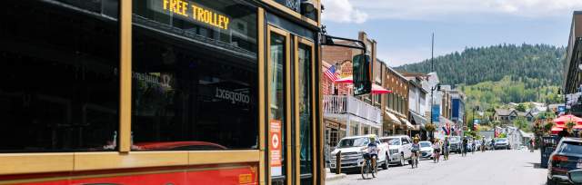 Trolly driving up main street during the summer