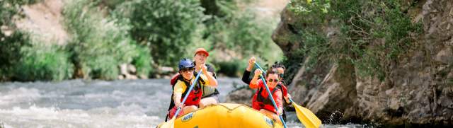 Group of people white water rafting