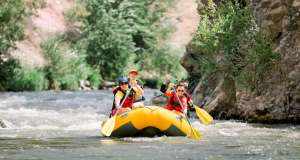 Group of people white water rafting