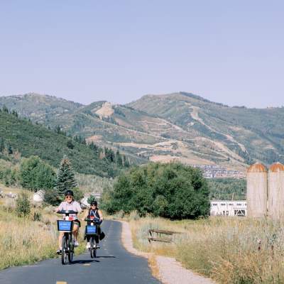 Two people riding summit bike share