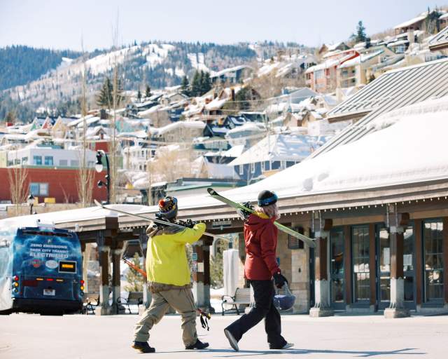 Skiers walking by old town transit station