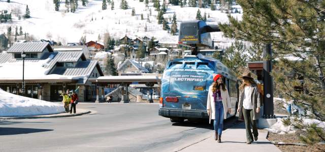 Girls walking past electric bus at Old Town transit Center