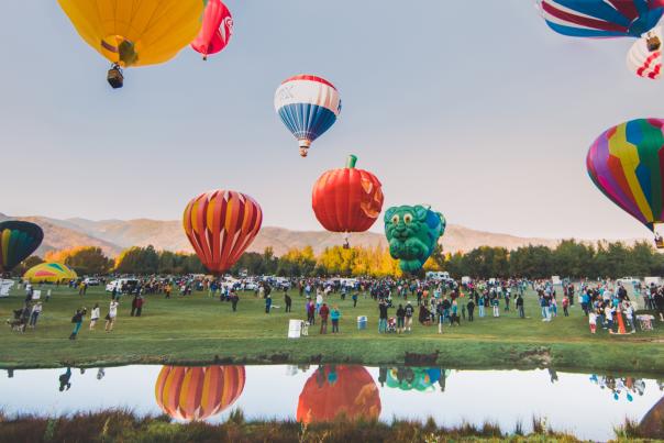 a group of hot air balloons taking off into the air