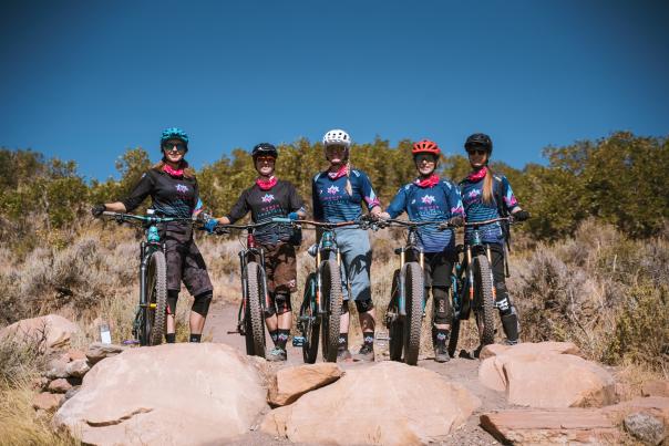 Women with mountains bikes smiling at the camera