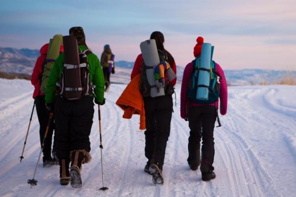 Yoga participants hiking in snow