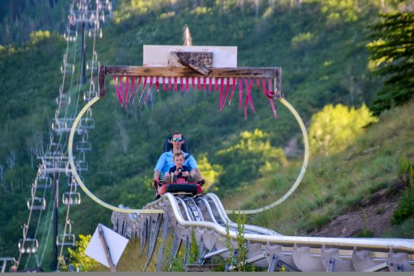 Father and Son ride down the alpine coaster at Park City Mountain