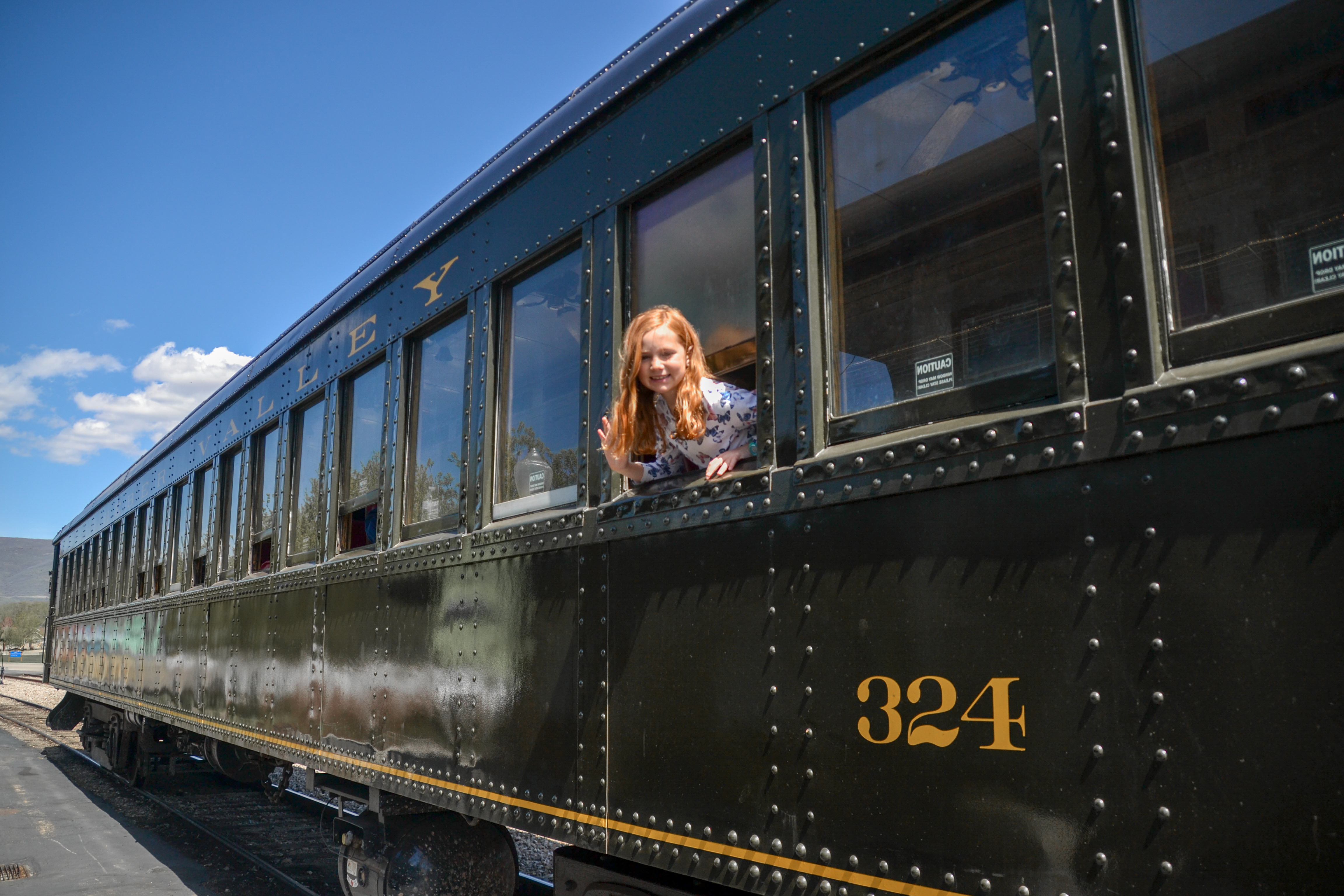 Little Girl Looking out the window of a train