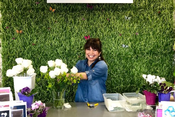 Women making floral arrangement with white roses