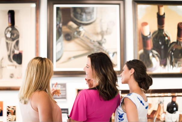 Three women viewing art and talking to each other