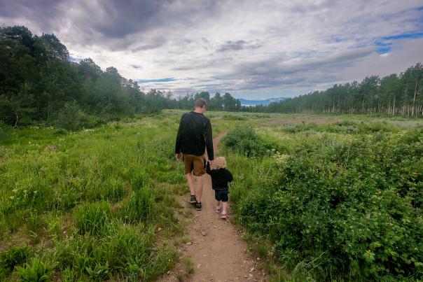 Father and son walking on a hiking trail