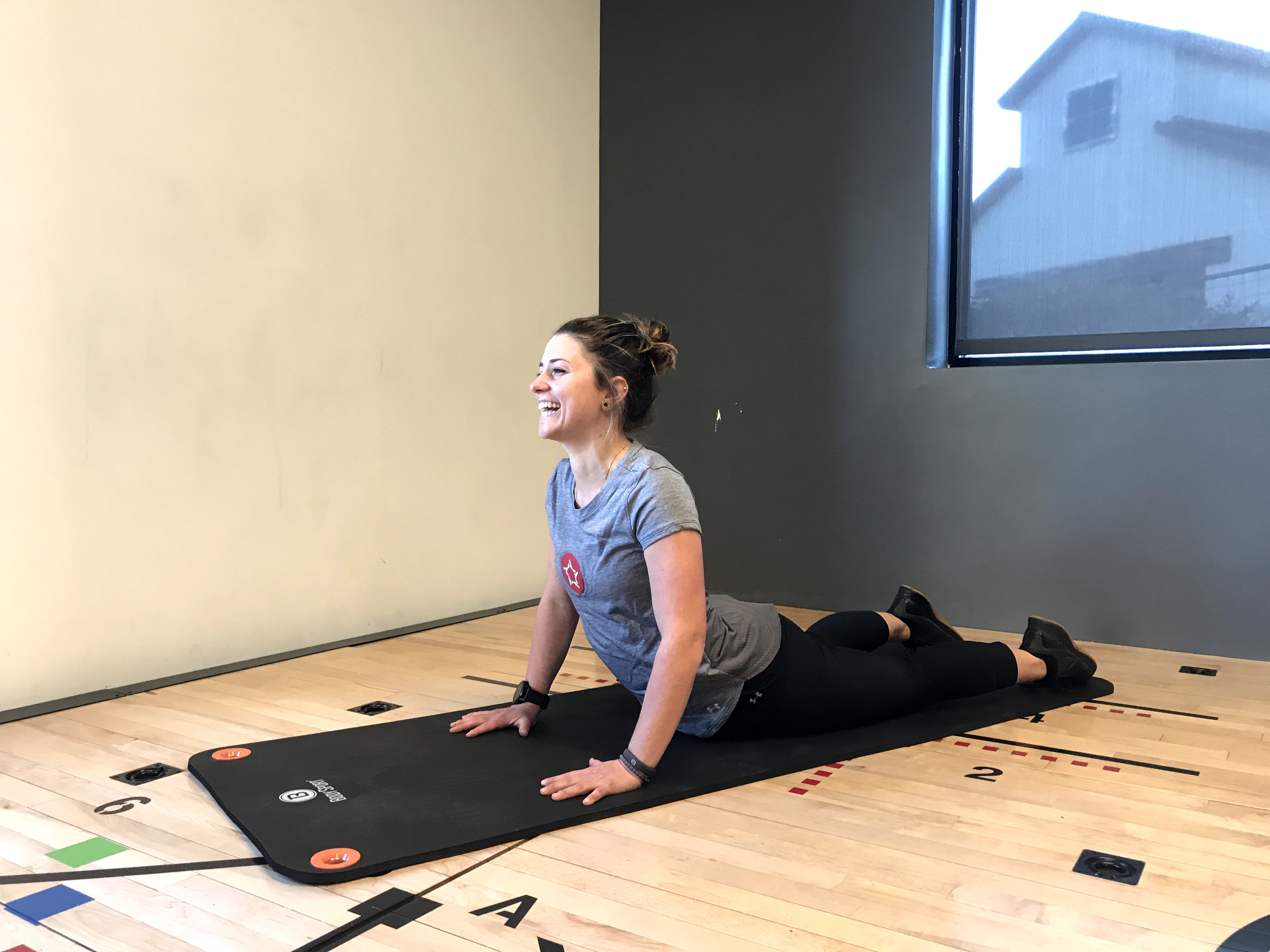 Instructor demonstrating "cobra pose"