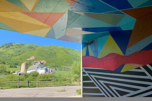 Artistic Mural in Tunnel with White Barn in the Back