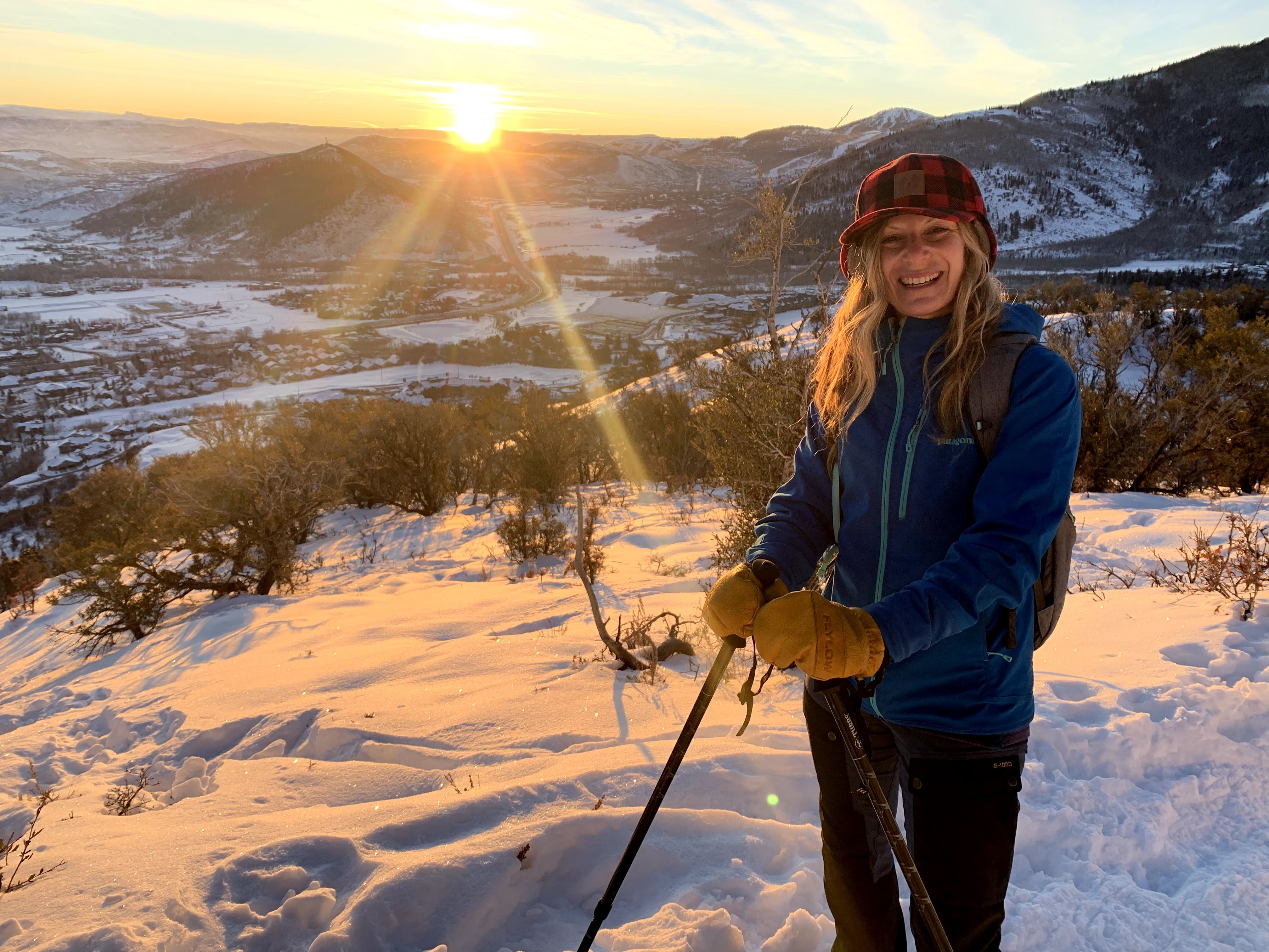 Woman posing for photo with scenic sun rise background