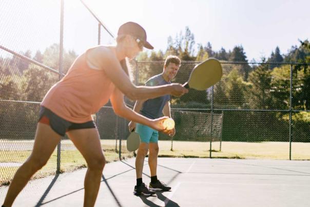 Two pickleball players begin a game at sunset in Park City, UT