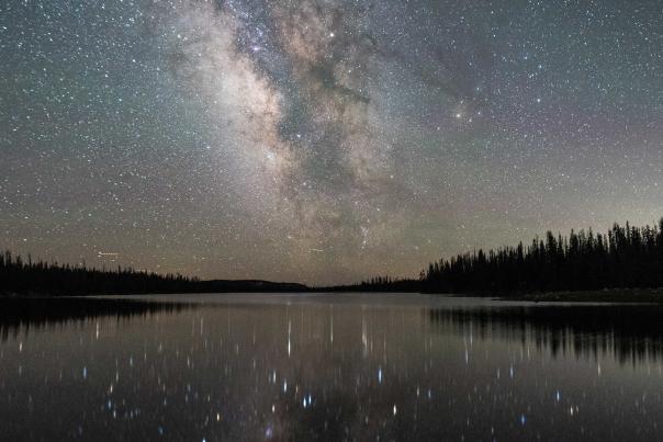 Stars and the Milky Way Galaxy reflecting off a still water lake near Park City, UT