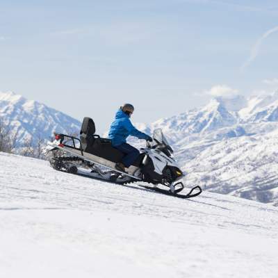 Snowmobile on Ridge with Timpanogos in the background