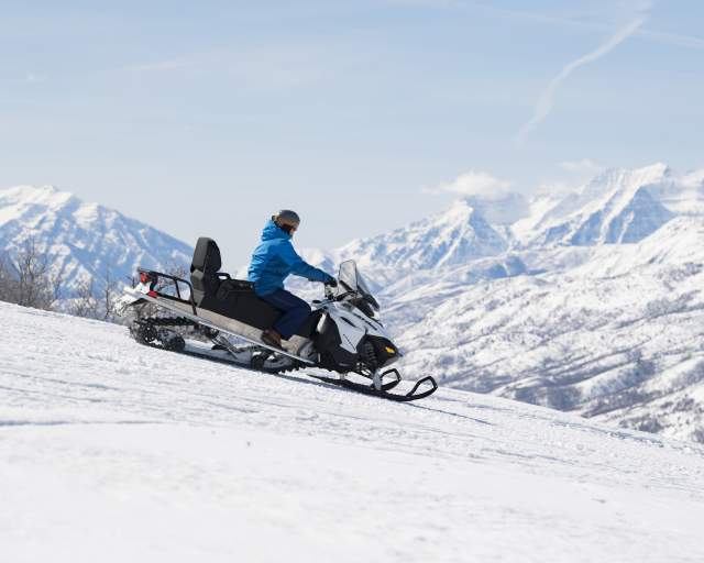 Snowmobile on Ridge with Timpanogos in the background