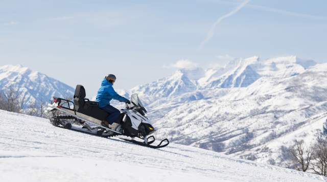 Snowmobile on Ridge with Timpanogos in the background