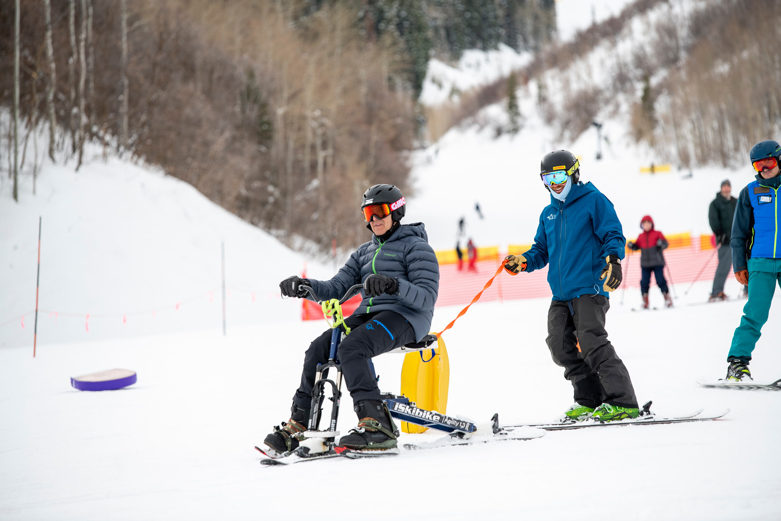 A man adaptive skiing in Park City, UT with the NAC