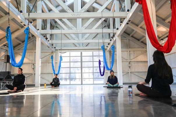 Four women sitting in a yoga class