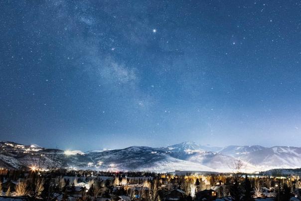 Stars above a brightly lit Park City, UT