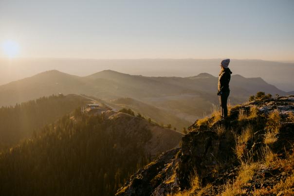 Woman on top of Mountain looking out at Park City, Utah