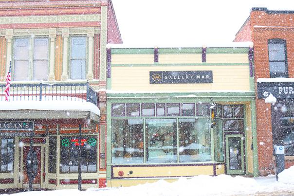 Snowy Sidewalk and Historic Buildings on Main Street