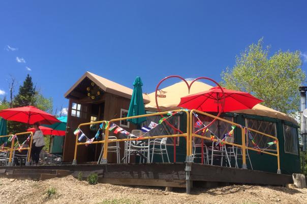 A patio with umbrellas outside of a yurt