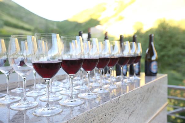 a row of red wine in glasses